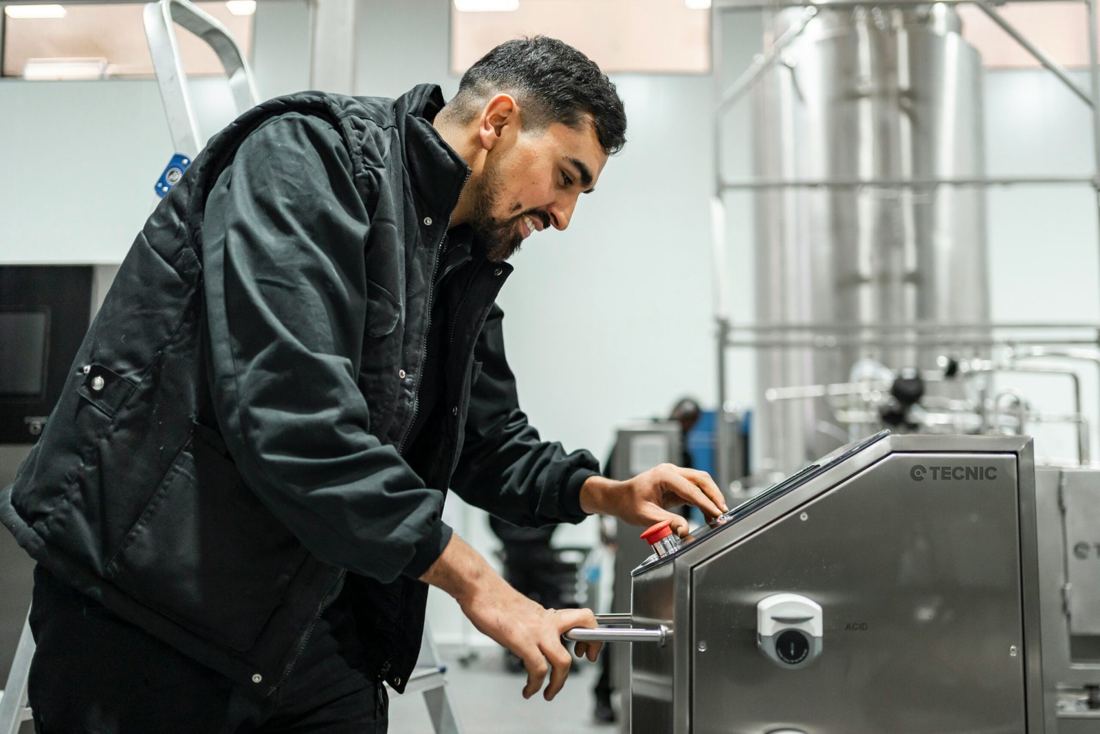 A man operates equipment in an industrial setting.