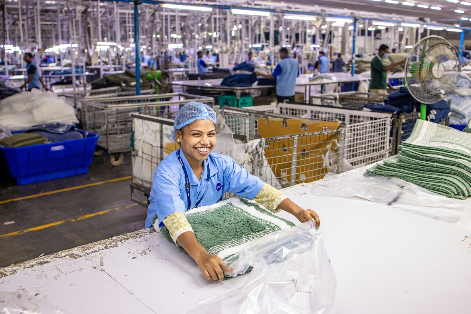 Woman works in a clothing manufacturing facility.