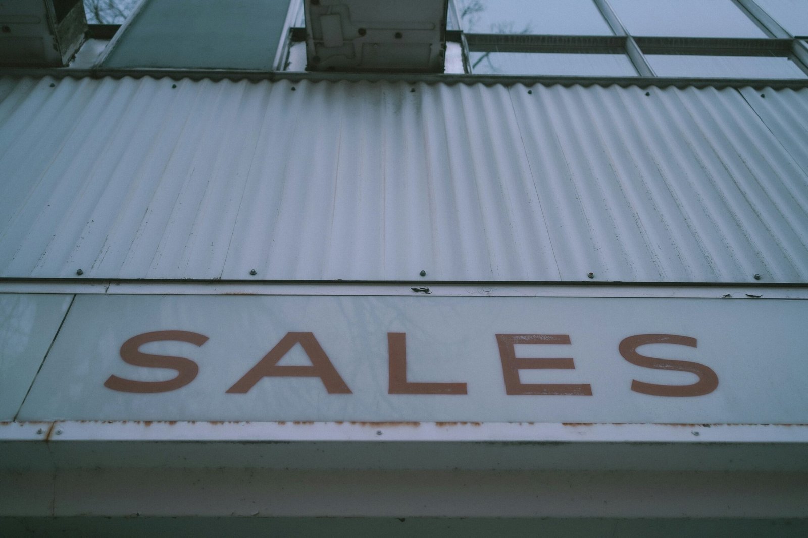 a sign that says sales on the side of a building