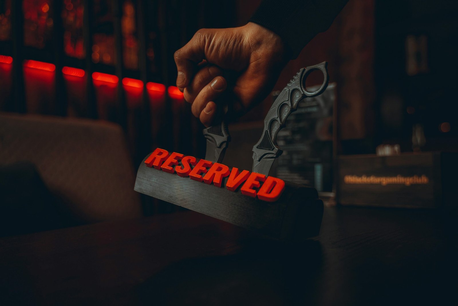 person holding a white and red love print wooden signage