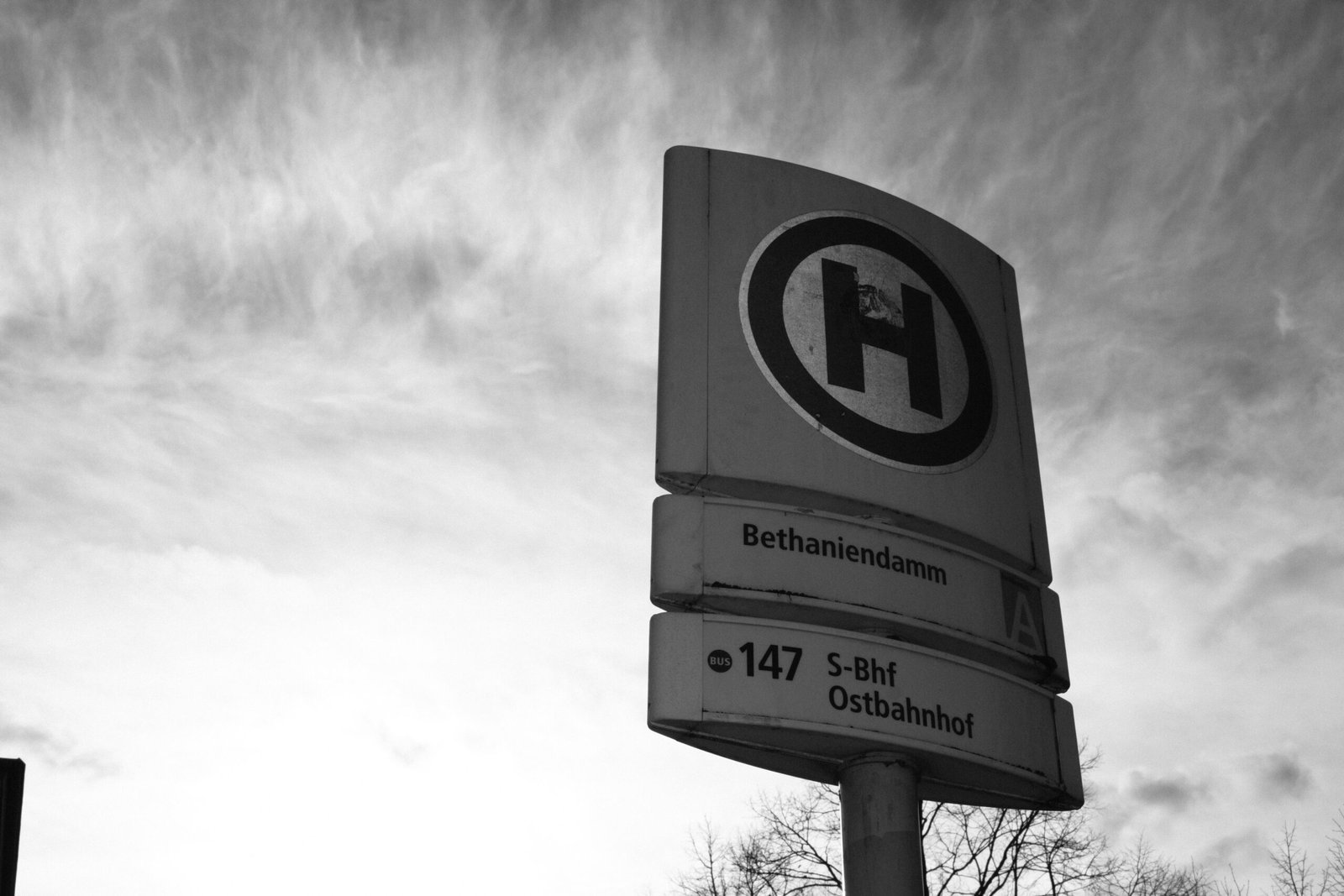 a black and white photo of a street sign
